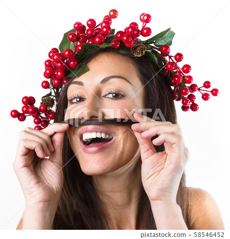Smiling woman with a christmas wreath on her head, 58546452