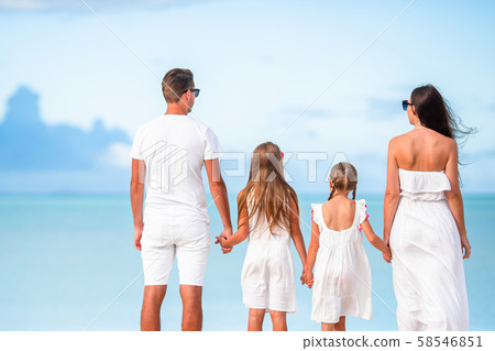 Young family of four on vacation have fun 58546851