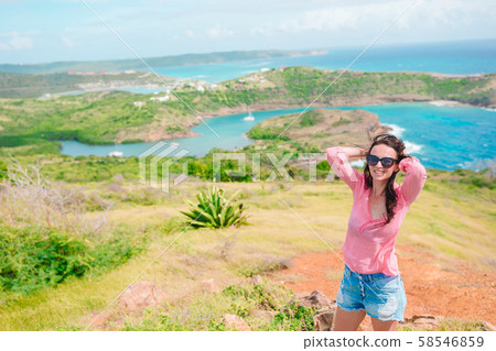 Young woman enjoying breathtaking views of beautiful landscape Young woman enjoying breathtaking views of beautiful landscape 58546859