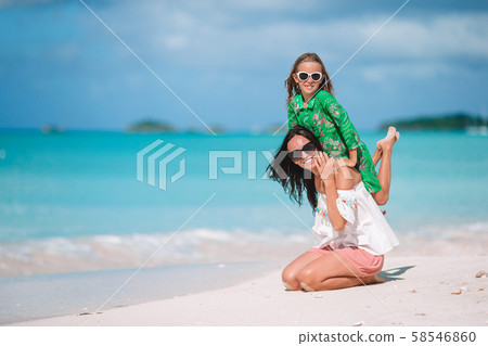 Beautiful mother and daughter on Caribbean beach Beautiful mother and daughter on Caribbean beach 58546860