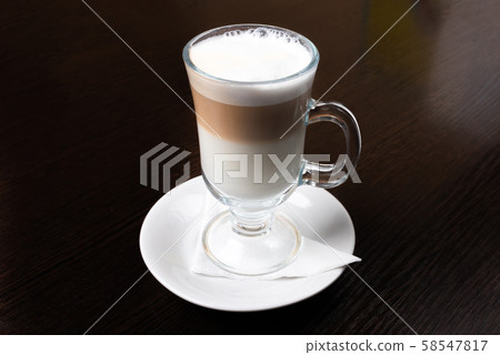 Mug of latte, on a dark, wooden background. Mug of latte, on a dark, wooden background. 58547817