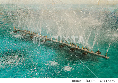 A water fountain sprinkling water on display 58547870