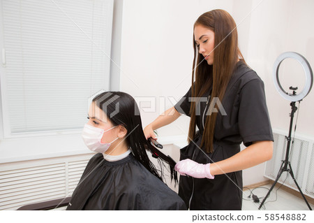The work of a hair stylist to straighten hair 58548882