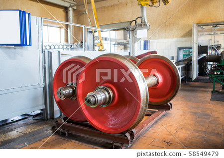 Railway wheelsets of red color in the repair shop. Railway wheelsets of red color in the repair shop. 58549479