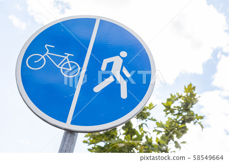 Close-up of roadsign Shared path for bikers and pedestrians against sky and tree 58549664