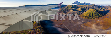 Wing of airplane and view of mountain Bromo vocano 58549830
