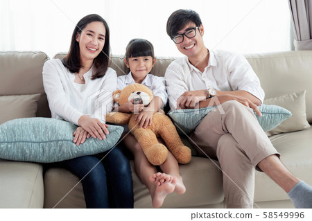 Asian family watching TV and sit on sofa in leving Asian family watching TV and sit on sofa in leving 58549996