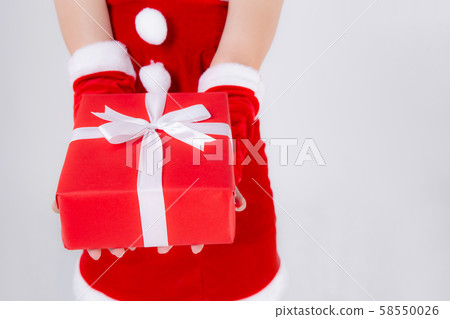 Closeup hand woman holding present box in xmas day with surprise isolated 58550026