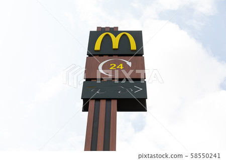 Minsk, Belarus - July 17, 2019: McDonald's 24/7 fastfood restaurant logo on board. McDonald's is a Minsk, Belarus - July 17, 2019: McDonald's 24/7 fastfood restaurant logo on board. McDonald's is a 58550241