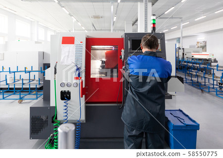Factory worker - operator of metal processing equipment 58550775