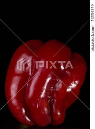 Red sweet pepper on a black background 58554339