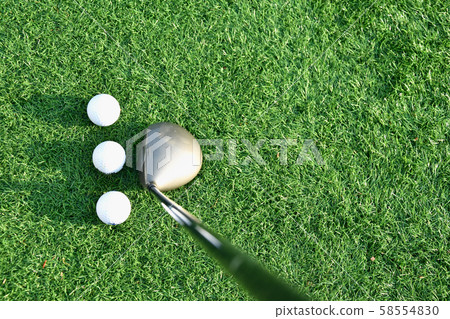 Stick with a ball on an artificial golf course Stick with a ball on an artificial golf course 58554830