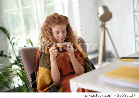 Woman drinking hot tea after coughing for long time Woman drinking hot tea after coughing for long time 58555137