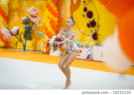 Beautiful little active gymnast girl with her performance on the carpet Beautiful little active gymnast girl with her performance on the carpet 58555230