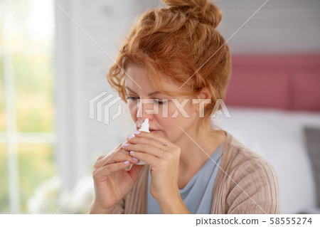 Woman having terrible day while suffering from stuffy nose 58555274