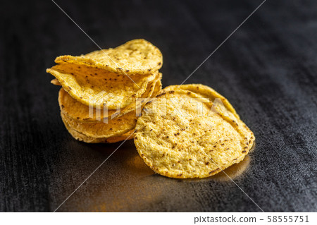 Round nacho chips. Yellow tortilla chips 58555751