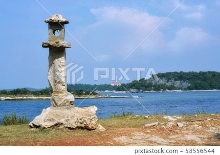 Stone lantern on the shore. 58556544