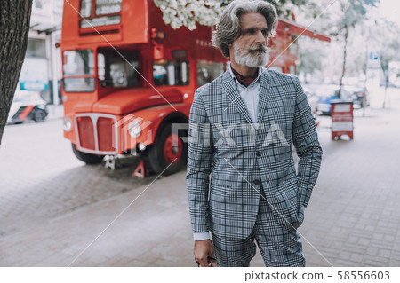 Attractive man in suit standing in the street stock photo Attractive man in suit standing in the street stock photo 58556603