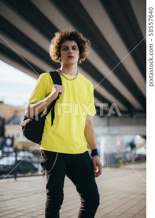 Young man with backpack outdoors stock photo Young man with backpack outdoors stock photo 58557640