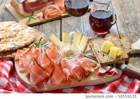 Typical South Tyrolean snack with bacon, horseradish, cheese and bread, served with local red wine 58559135
