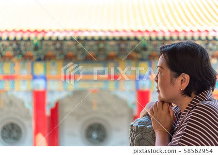 Woman at Wat Boromracha Kanchanapisek Anusorn Woman at Wat Boromracha Kanchanapisek Anusorn 58562954