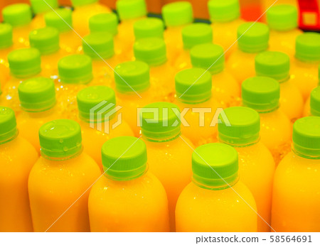 Fresh orange or lemon juice packed in plastic bottles  58564691