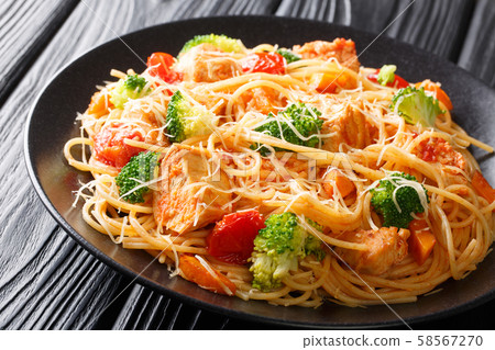 Tasty pasta with chicken and vegetables close-up Tasty pasta with chicken and vegetables close-up 58567270