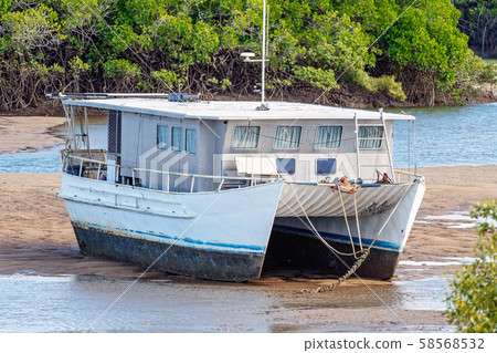 Boat Beached In The Mud At Low Tide Boat Beached In The Mud At Low Tide 58568532