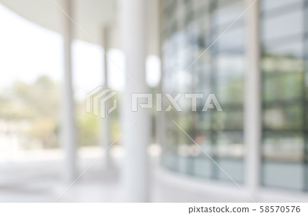 Blur office background building exterior view to lobby glass window wall with blurry light bokeh Blur office background building exterior view to lobby glass window wall with blurry light bokeh 58570576