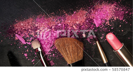 A panorama of make-up brushes, lipstick, and crushed cosmetics, shot from the top on a black A panorama of make-up brushes, lipstick, and crushed cosmetics, shot from the top on a black 58570847