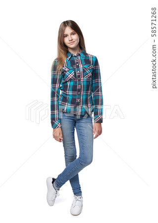 Teen girl in checkered shirt standing casually 58571268