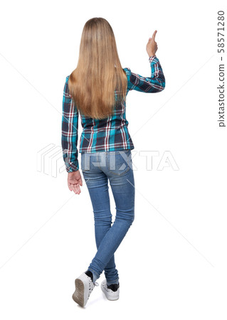 Teen girl in checkered shirt standing casually Teen girl in checkered shirt standing casually 58571280