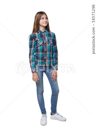 Teen girl in checkered shirt standing casually 58571296