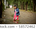 Kids playing on a rainy day 58572462
