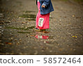 Kids playing on a rainy day 58572464