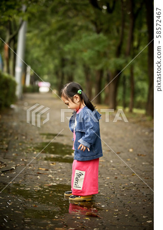 Kids playing on a rainy day Kids playing on a rainy day 58572467