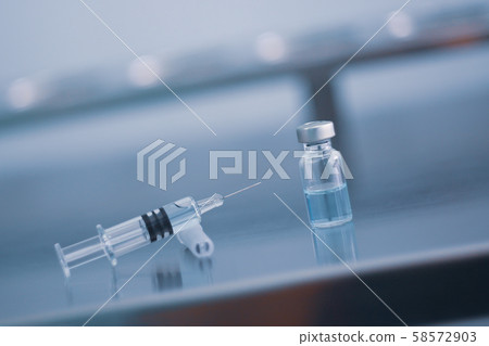 Vaccine vial dose flu shot drug needle syringe,medical concept vaccination hypodermic injection treatment disease care hospital prevention immunization illness disease  baby child.blue background  58572903