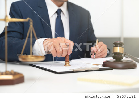 Lawyer or attorney working with papers in office Lawyer or attorney working with papers in office 58573181