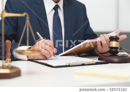 Lawyer or attorney working with papers in office Lawyer or attorney working with papers in office 58573182