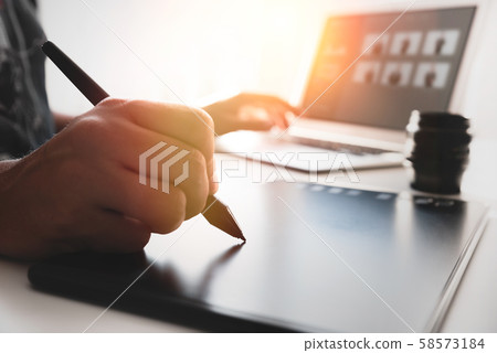 Graphic designer at work in office Graphic designer at work in office 58573184