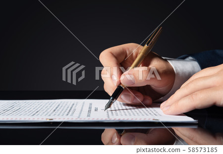 Lawyer, notary, attorney signs document Lawyer, notary, attorney signs document 58573185
