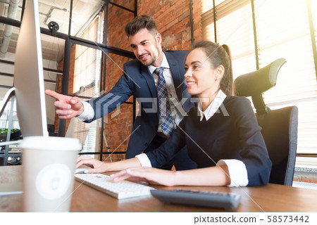 Team business couple co-working in office Team business couple co-working in office 58573442