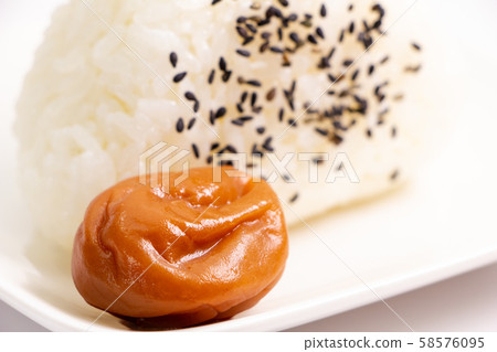 Plum dried (seasoned plum dried and honey flavored). With sesame salt rice balls. Plum dried (seasoned plum dried and honey flavored). With sesame salt rice balls. 58576095
