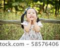 Girl playing in the forest 58576406