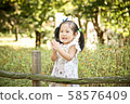 Girl playing in the forest 58576409