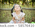 Girl playing in the forest 58576410