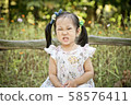 Girl playing in the forest 58576411