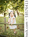 Girl playing in the forest 58576413