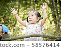 Girl playing in the forest 58576414