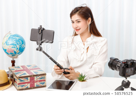 Young travel blogger girl reviewing in front of Young travel blogger girl reviewing in front of 58576525